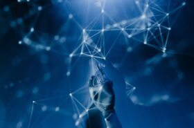 Free A robotic hand reaching into a digital network on a blue background, symbolizing AI technology. Stock Photo